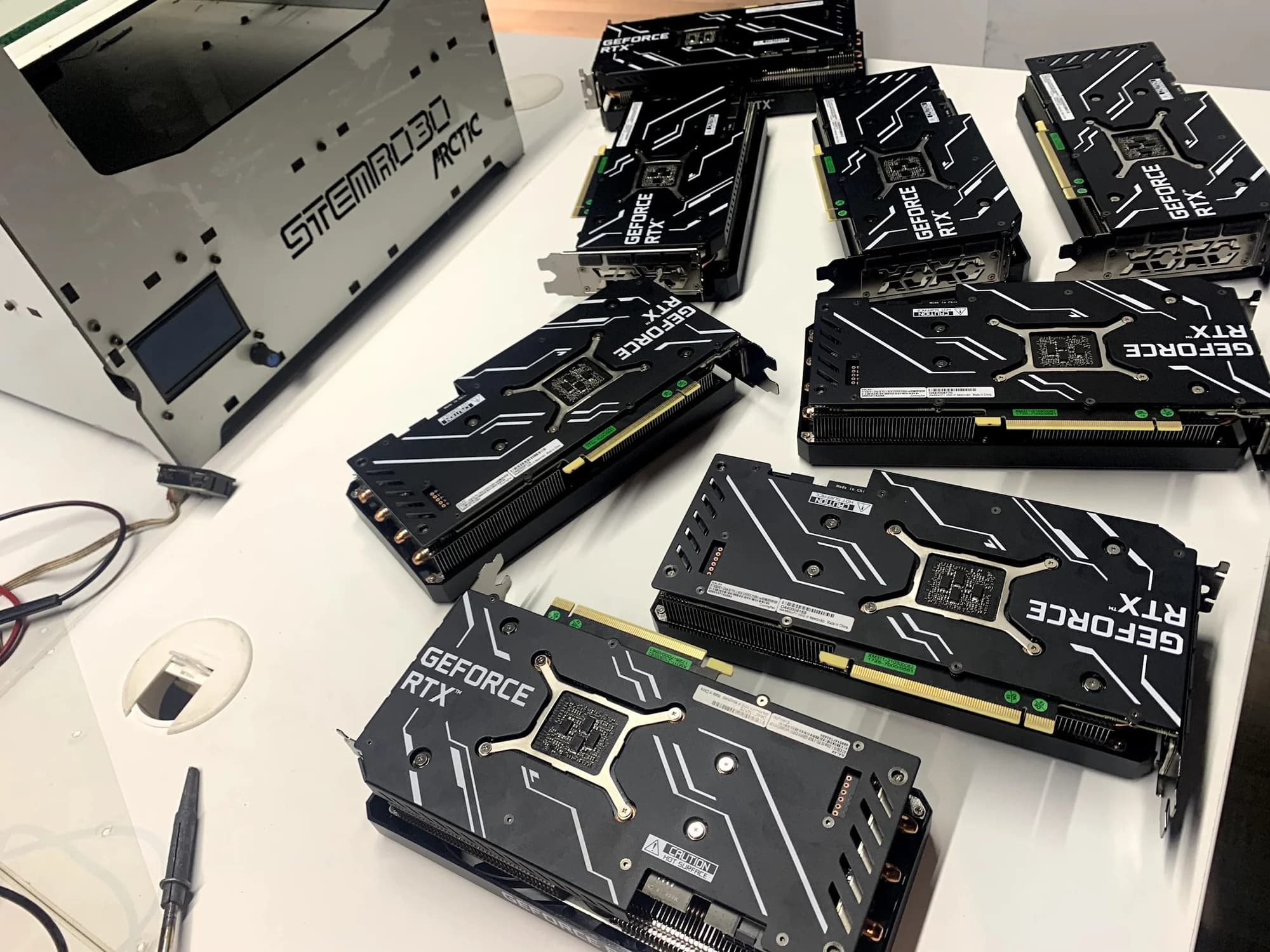 GeForce RTX GPUs staged for assembly on engineering workbench